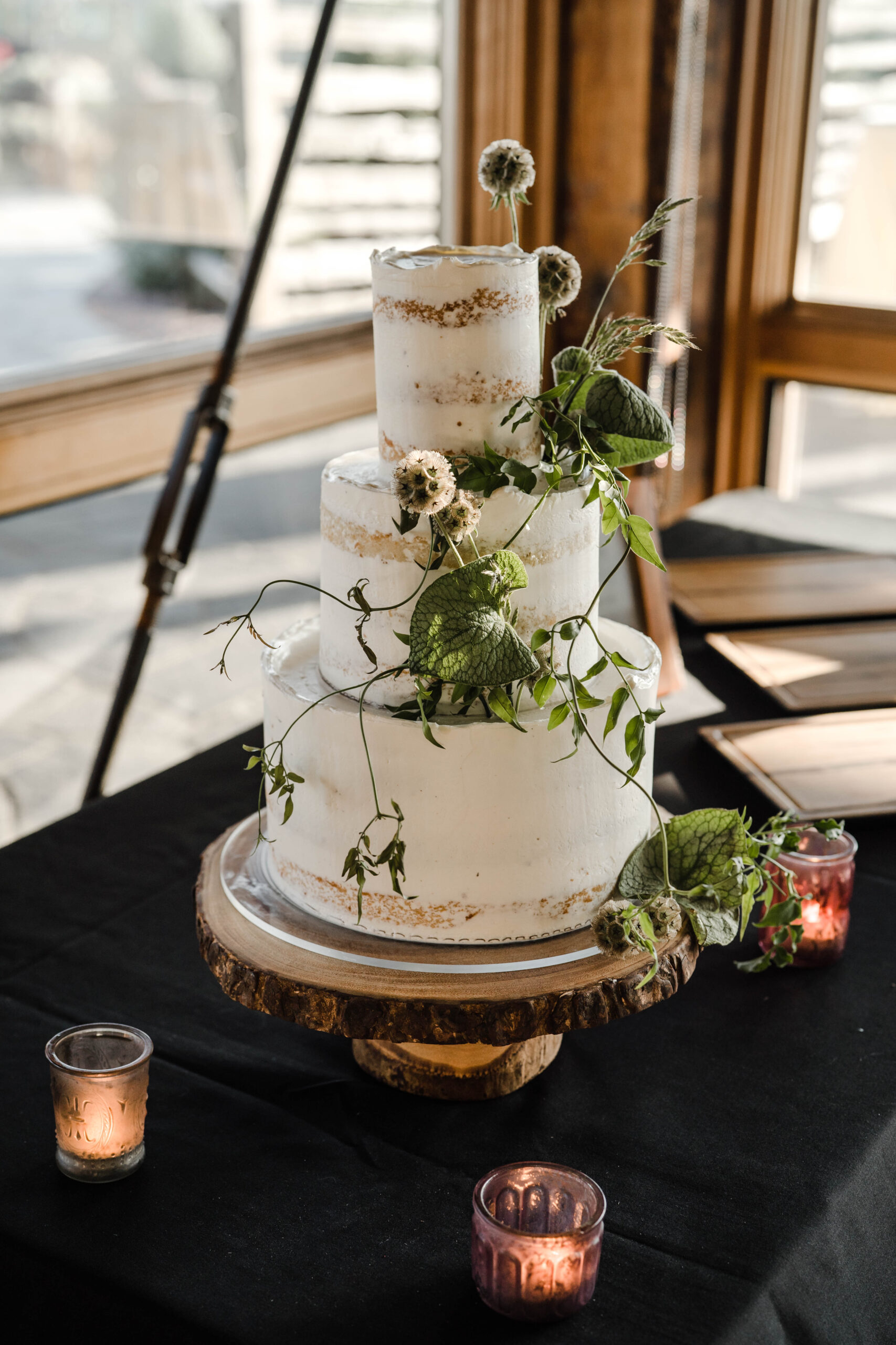 Crumb Cakery - Whimsical semi-naked wedding cake with fresh vines and greenery - Nature inspired wedding cakes